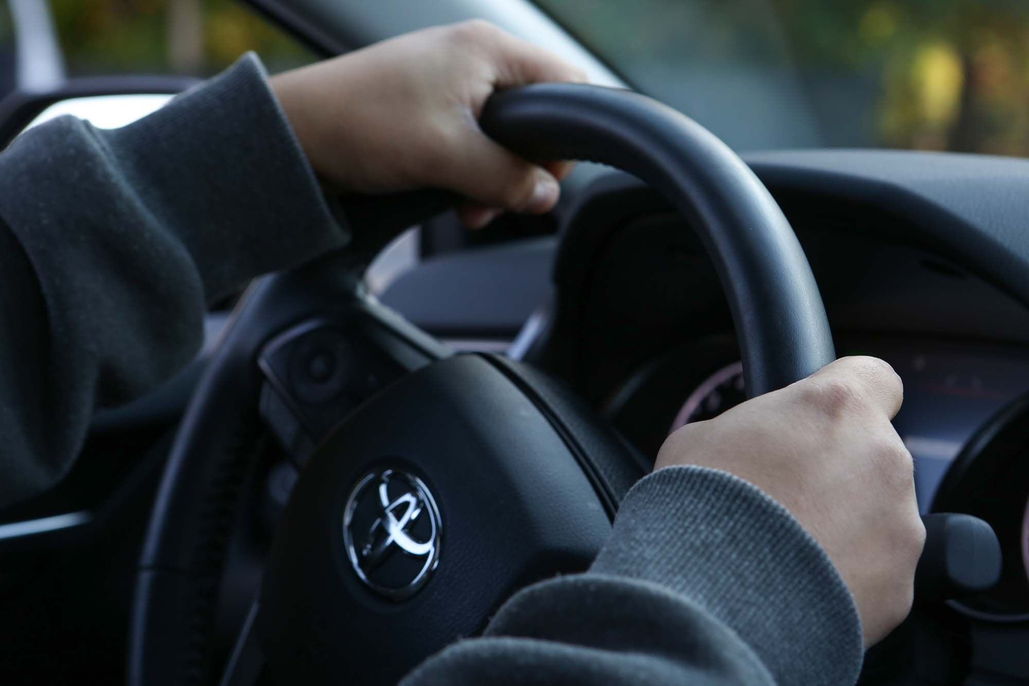 Closeup of hands on steering wheel